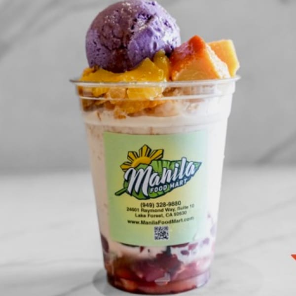 Manila Food Mart's Halo-Halo dessert with ube ice cream, leche flan, and fruit in a clear cup.